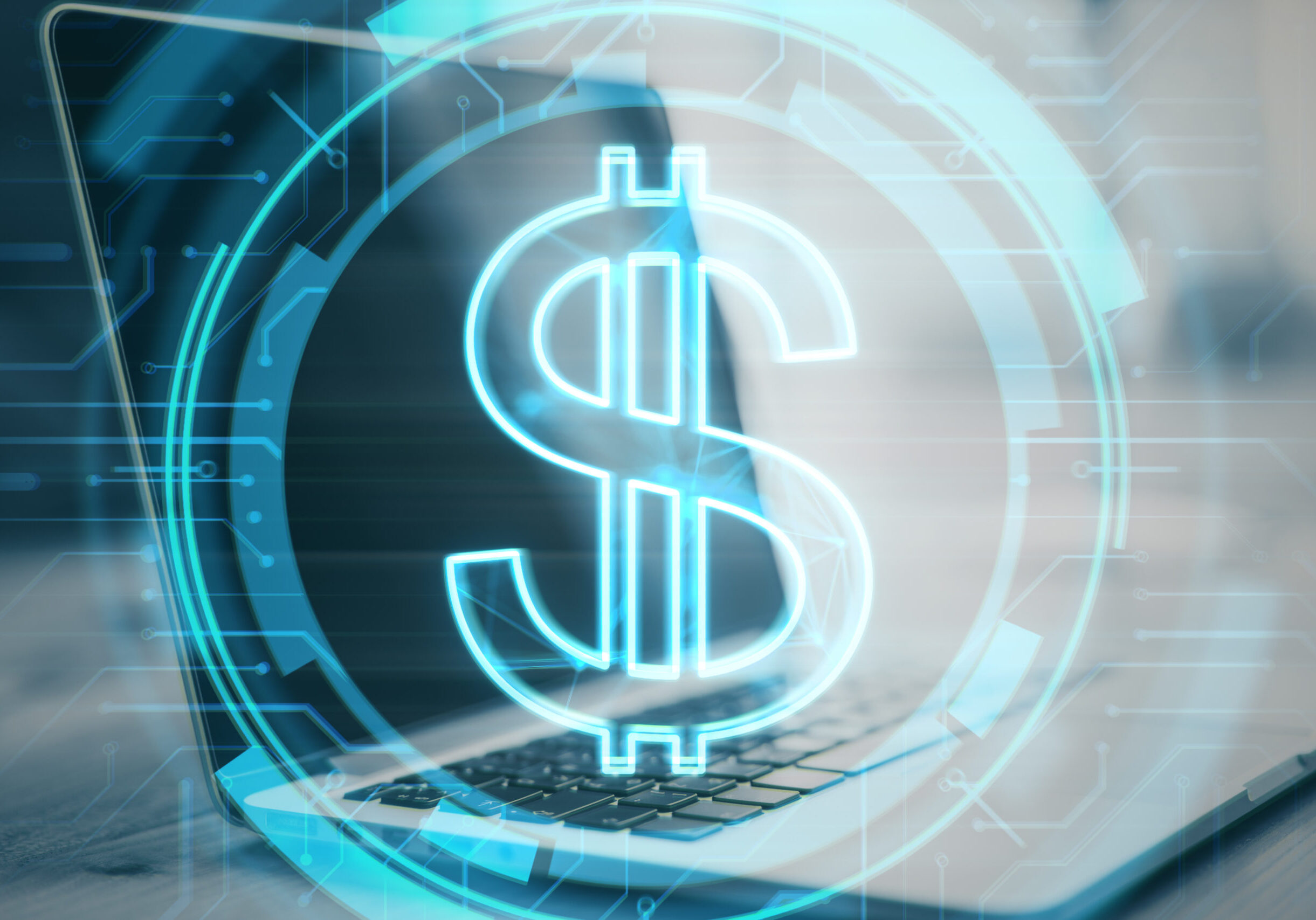 Close up of desktop with laptop and glowing dollar sign on blurry background. Money and online banking concept. Double exposure